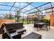 Screened in patio offers hot tub, lounge chairs and dining area for ideal relaxation at 5766 Lesabre Dr, Kissimmee, FL 34746