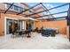Enclosed patio area with spa, outdoor dining, and lounge chairs for optimal relaxation at 5766 Lesabre Dr, Kissimmee, FL 34746