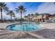 Resort-style pool features palm trees, lounge chairs, and umbrellas for a relaxing vacation experience at 5766 Lesabre Dr, Kissimmee, FL 34746