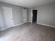 Bedroom featuring neutral paint, wood flooring, and multiple doors at 6046 Village Cir # 6046, Orlando, FL 32822