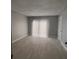 Neutral bedroom featuring tile floors, natural light, and a door to the exterior at 6046 Village Cir # 6046, Orlando, FL 32822