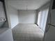 Open dining area features tile floors, a chandelier, and sliding glass door at 6046 Village Cir # 6046, Orlando, FL 32822