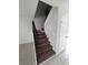 View of carpeted staircase featuring decorative wrought iron banister and freshly painted walls at 6046 Village Cir # 6046, Orlando, FL 32822