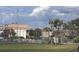 Community tennis court surrounded by lush greenery and mature trees at 6046 Village Cir # 6046, Orlando, FL 32822