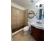 Well-lit bathroom with tiled walk-in shower and vanity with dark wood at 620 Georgetown Dr # 620, Casselberry, FL 32707