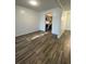 Open dining area with wood-look tile flooring leading into a renovated kitchen at 620 Georgetown Dr # 620, Casselberry, FL 32707