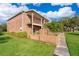 Charming two-story brick home with a balcony and a well-maintained lawn with lush green landscaping at 620 Georgetown Dr # 620, Casselberry, FL 32707