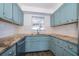 Cozy kitchen with granite countertops, classic blue cabinets, and stainless steel appliances at 620 Georgetown Dr # 620, Casselberry, FL 32707