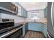 Updated kitchen featuring stainless steel appliances, light blue cabinets, and granite countertops at 620 Georgetown Dr # 620, Casselberry, FL 32707
