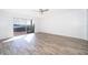 Bright, spacious living area featuring wood-look tile flooring, neutral walls, and sliding glass doors to the outdoors at 620 Georgetown Dr # 620, Casselberry, FL 32707