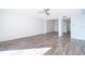 Bright, spacious living room with wood-look tile flooring, ceiling fan, and view to other rooms at 620 Georgetown Dr # 620, Casselberry, FL 32707