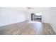 Bright, spacious living room with wood-look tile flooring and a sliding glass door leading to a patio at 620 Georgetown Dr # 620, Casselberry, FL 32707