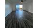 Open living room boasts sleek wood-look tile floors and sliding glass doors to the patio at 620 Georgetown Dr # 620, Casselberry, FL 32707