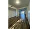 Living room with wood floors, ceiling fan, and a view of the balcony at 620 Georgetown Dr # 620, Casselberry, FL 32707