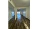 Spacious living room featuring wood-look tile flooring and a scenic lake view at 620 Georgetown Dr # 620, Casselberry, FL 32707