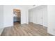 View of the living room showcasing modern wood-look tile flooring and open access to the kitchen at 620 Georgetown Dr # 620, Casselberry, FL 32707