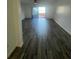 Living room featuring stylish wood-look tile floors and sliding glass doors to the patio at 620 Georgetown Dr # 620, Casselberry, FL 32707