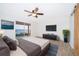Bright main bedroom boasts a ceiling fan, TV, and sliding doors with a serene water view at 620 Georgetown Dr # 620, Casselberry, FL 32707