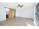 Spacious main bedroom with modern floors, ensuite bathroom access, barn door, and sliding glass doors at 620 Georgetown Dr # 620, Casselberry, FL 32707