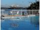Sparkling pool with lake views and lounge seating, perfect for relaxation at 620 Georgetown Dr # 620, Casselberry, FL 32707