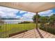 Outdoor porch with metal railing overlooking a well-maintained lawn and lake at 620 Georgetown Dr # 620, Casselberry, FL 32707