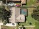 Aerial view featuring screened-in pool, driveway, and well-maintained roof at 685 Vistawilla Dr, Winter Springs, FL 32708