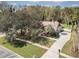 Aerial view of a home with a manicured lawn and mature trees in a quiet residential neighborhood at 685 Vistawilla Dr, Winter Springs, FL 32708