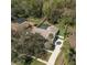 Aerial view of home with screened-in pool, mature trees and landscaping at 685 Vistawilla Dr, Winter Springs, FL 32708