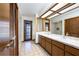 Bathroom featuring a double sink vanity and door that leads to backyard swimming pool at 685 Vistawilla Dr, Winter Springs, FL 32708