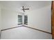 Bedroom featuring neutral carpet, two windows, and view of backyard with swimming pool at 685 Vistawilla Dr, Winter Springs, FL 32708