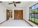 Bedroom featuring a ceiling fan, closet with folding doors, and a view to the backyard at 685 Vistawilla Dr, Winter Springs, FL 32708