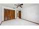 Bedroom features a ceiling fan, closet with folding doors, and a view to another room at 685 Vistawilla Dr, Winter Springs, FL 32708