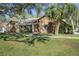 Well-maintained single-Gathering home featuring stone accents, mature trees, and lush landscaping at 685 Vistawilla Dr, Winter Springs, FL 32708