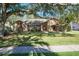 Charming single-Gathering home with a stone and wood facade, mature trees, and a well-maintained lawn at 685 Vistawilla Dr, Winter Springs, FL 32708