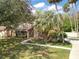 Attractive home with stone accents, mature palm trees, and a spacious front yard at 685 Vistawilla Dr, Winter Springs, FL 32708