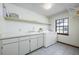 Bright laundry room with modern washer and dryer, sink, and ample counter space for folding at 685 Vistawilla Dr, Winter Springs, FL 32708