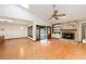 Open-concept living room featuring wood floors, a stone fireplace, access to the pool, and plenty of natural light at 685 Vistawilla Dr, Winter Springs, FL 32708