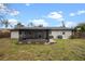 An inviting backyard showcasing a screened lanai, patio, and a lush green lawn at 7319 Blue Jacket W Pl, Winter Park, FL 32792