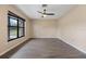 Living room featuring hardwood floors and a large window providing lots of natural light at 7319 Blue Jacket W Pl, Winter Park, FL 32792