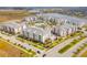 Aerial view of new community featuring modern apartments, a pool, and well-maintained landscaping at 7517 Laureate Blvd # 4206, Orlando, FL 32827
