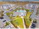 An aerial shot of a community featuring a pool, clubhouse, and meticulously manicured landscaping at 7517 Laureate Blvd # 4206, Orlando, FL 32827