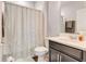 Cozy bathroom features a shower with curtain and a vanity with storage at 7517 Laureate Blvd # 4206, Orlando, FL 32827