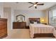 Traditional bedroom with neutral carpet, ceiling fan, and wood furniture at 7517 Laureate Blvd # 4206, Orlando, FL 32827