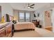 Bright bedroom with neutral carpet, ceiling fan, wood furniture, and natural light at 7517 Laureate Blvd # 4206, Orlando, FL 32827