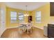 The dining area features wood floors, natural light, and seating for four at 7517 Laureate Blvd # 4206, Orlando, FL 32827