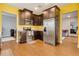 Well-lit kitchen features wood floors, stainless steel appliances, and dark wood cabinets at 7517 Laureate Blvd # 4206, Orlando, FL 32827