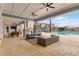 Covered poolside patio with tables, seating, and ceiling fans at 7517 Laureate Blvd # 4206, Orlando, FL 32827