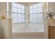 This luxurious bathroom features a large soaking tub with frosted windows for privacy at 7902 Silver Bass Ct, Kissimmee, FL 34747