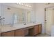 Spacious bathroom with double sinks, white countertops, and a glass-enclosed shower at 7902 Silver Bass Ct, Kissimmee, FL 34747