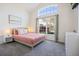 Bright bedroom featuring a vaulted ceiling, large window, and a cozy bed with a light pink duvet at 7902 Silver Bass Ct, Kissimmee, FL 34747
